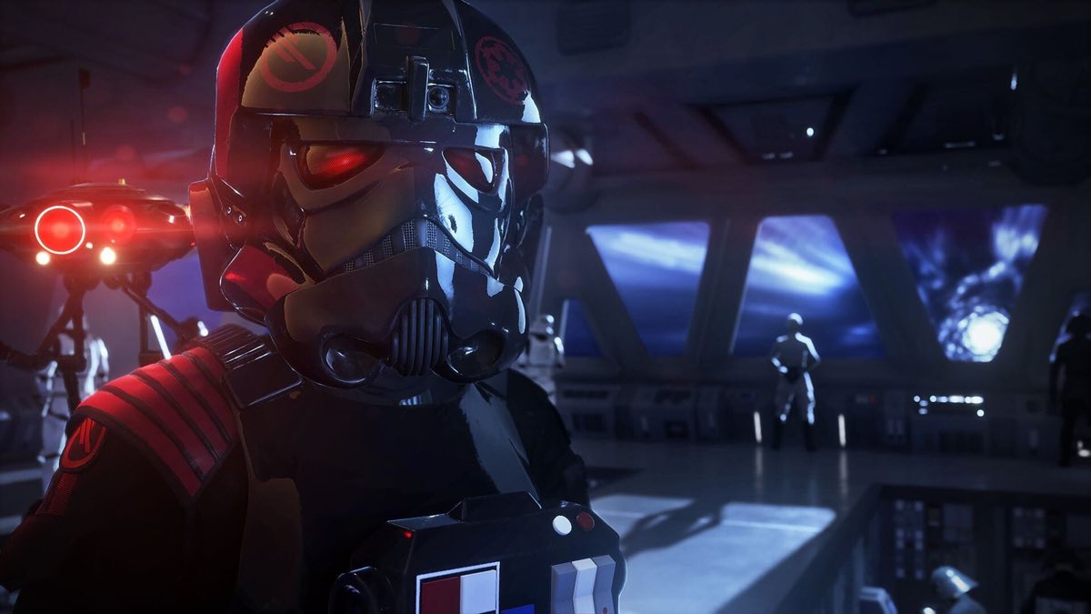Vista en primera persona de un pueblo desértico de edificios de adobe, con un blaster con mira en la mano, en Star Wars Battlefront II